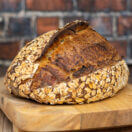 honey oat sourdough bread on a board